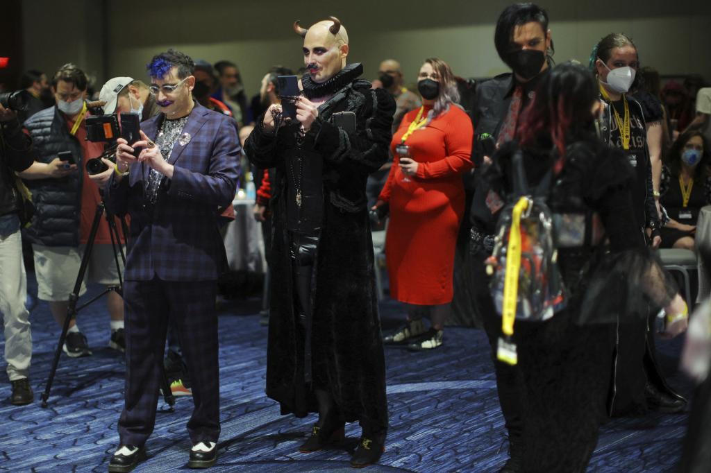 Participantes toman fotos durante el congreso satanista en Boston (EEUU).